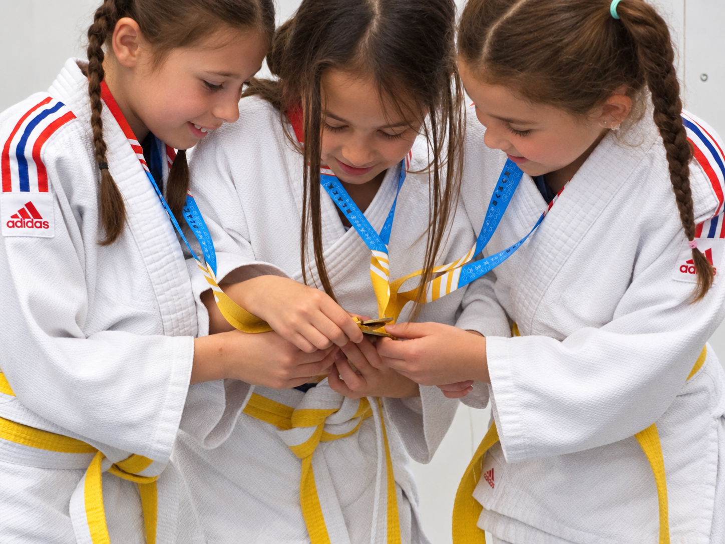 Young judoka sharing a medal moment